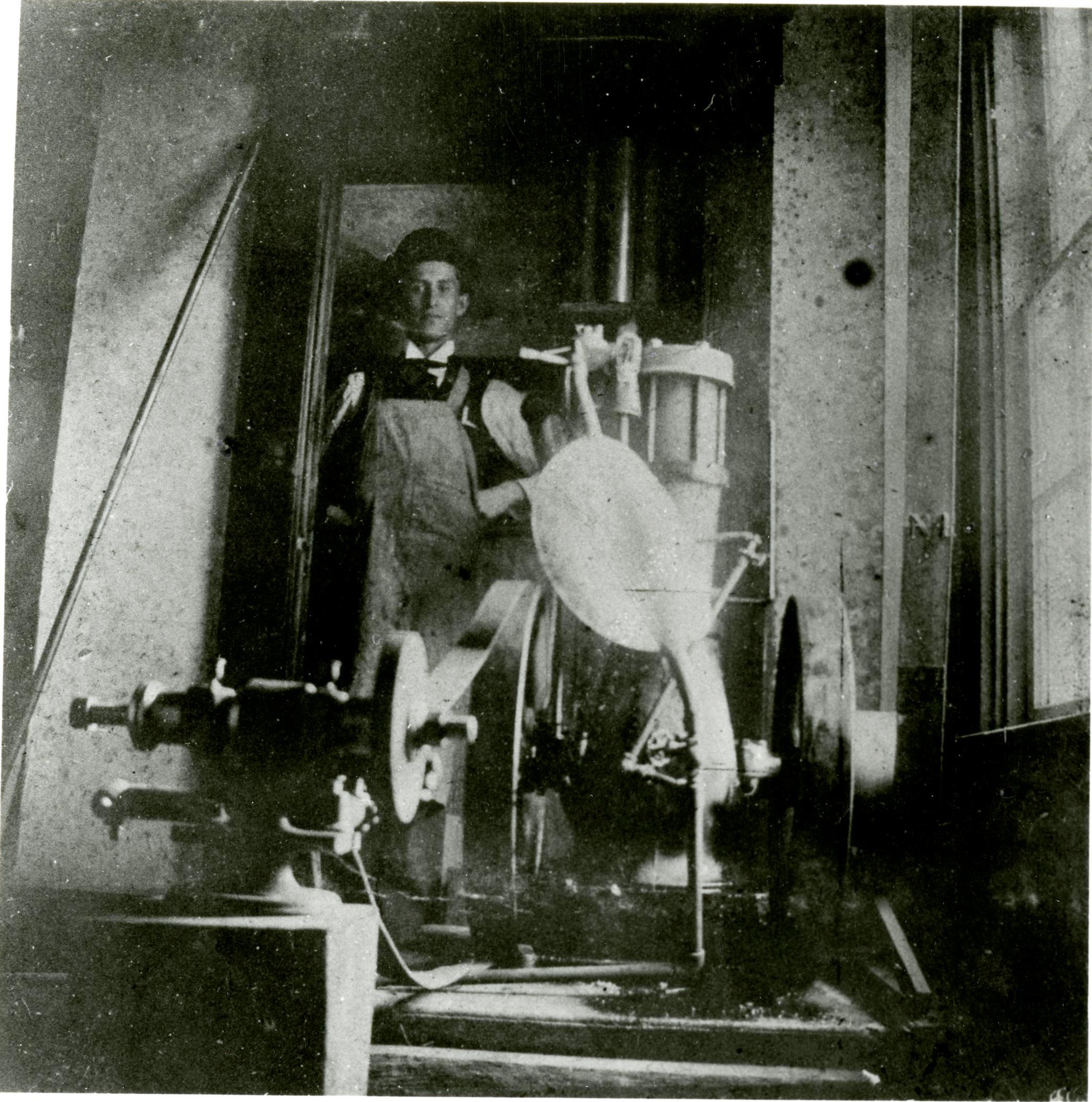 Orville Wright in a work apron at the Wright Cycle Company, c. 1890s